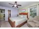 A bright main bedroom with a ceiling fan, chair and wooden furniture at 205 Cedar Dr, Zebulon, NC 27597