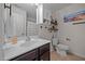 Well-lit bathroom features a single sink vanity, decorative shelving, and tiled floor at 206 Vandercroft Way, Bunnlevel, NC 28323
