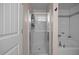 A well-lit bathroom features a standing shower with glass door and a soaking tub with white tile surround at 206 Vandercroft Way, Bunnlevel, NC 28323