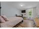 Bright bedroom featuring a bed, tv, wood floors, natural light, and a decorative vanity at 206 Vandercroft Way, Bunnlevel, NC 28323