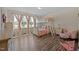 Comfortable bedroom with a bunk bed, natural light, and hardwood floors at 206 Vandercroft Way, Bunnlevel, NC 28323