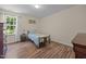 Bedroom features a single bed, wood floors, natural light, and dark wood accents at 206 Vandercroft Way, Bunnlevel, NC 28323