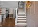 Open entryway with hardwood floors, staircase, and natural light, creating a welcoming and spacious entrance at 206 Vandercroft Way, Bunnlevel, NC 28323