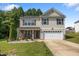 Charming two-story home with a well-manicured lawn, covered front porch, and two-car garage, perfect for suburban living at 206 Vandercroft Way, Bunnlevel, NC 28323