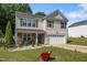 Lovely two-story home with a welcoming front porch and lush green lawn, offering a cozy suburban lifestyle at 206 Vandercroft Way, Bunnlevel, NC 28323