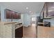 Modern kitchen featuring stainless steel appliances, granite countertops, and ample cabinet space at 206 Vandercroft Way, Bunnlevel, NC 28323