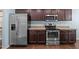 Well-equipped kitchen featuring stainless steel appliances and dark wood cabinets at 206 Vandercroft Way, Bunnlevel, NC 28323