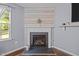Bright living room features hardwood floors and a charming fireplace with decorative mantle at 206 Vandercroft Way, Bunnlevel, NC 28323
