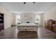 Bright main bedroom featuring wood floors, lots of natural light, and a large bed at 206 Vandercroft Way, Bunnlevel, NC 28323