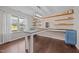 Bright office space with custom desk, shelving, and large windows, ideal for productivity and comfort at 206 Vandercroft Way, Bunnlevel, NC 28323
