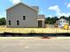 Gray two-story new construction home featuring bright white trim, and black landscape safety fencing at 21 Windflower Ct # Homesite 11, Clayton, NC 27520