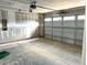 Spacious two car garage shows partially finished drywall, garage door with windows, and concrete floor at 21 Windflower Ct # Homesite 11, Clayton, NC 27520