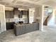 Spacious kitchen features modern cabinets and island, offering a great space for cooking and entertaining at 21 Windflower Ct # Homesite 11, Clayton, NC 27520