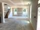Open-concept living area with staircase and large windows, ideal for modern living at 21 Windflower Ct # Homesite 11, Clayton, NC 27520