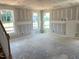 Spacious living room featuring three large windows offering ample natural light at 21 Windflower Ct # Homesite 11, Clayton, NC 27520