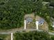 Overhead view of two beautiful homes nestled in a verdant, forested landscape and lengthy driveways at 225 Whistlers Cv, Louisburg, NC 27549