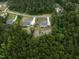 Aerial view of the house showcasing its position in a serene, wooded location with spacious lots at 225 Whistlers Cv, Louisburg, NC 27549