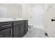 Modern bathroom features a walk-in shower, decorative tile flooring, a vanity, and updated fixtures at 225 Whistlers Cv, Louisburg, NC 27549
