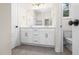 Bathroom featuring a double vanity with white cabinetry, and a large mirror with modern lighting at 225 Whistlers Cv, Louisburg, NC 27549