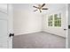 Cozy bedroom features plush carpeting, a ceiling fan, and a window that offers natural light at 225 Whistlers Cv, Louisburg, NC 27549