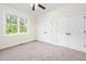 Comfortable bedroom featuring carpeting, a ceiling fan, a window, and dual closets for storage at 225 Whistlers Cv, Louisburg, NC 27549