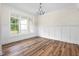Dining room features wood floors, modern wainscoting, elegant lighting and a large bright window at 225 Whistlers Cv, Louisburg, NC 27549