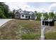Beautifully landscaped home with a combination of white siding and stone accents, complemented by a mailbox at 225 Whistlers Cv, Louisburg, NC 27549