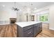 Open-concept kitchen with white countertops, stainless steel appliances and large center island with seating at 225 Whistlers Cv, Louisburg, NC 27549