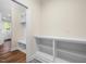 Well-organized mudroom with built-in shelving, bench seating, and decorative tile flooring at 225 Whistlers Cv, Louisburg, NC 27549