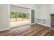 A transition from indoors to an outdoor screened-in patio with wood floors and views of the surrounding woods at 225 Whistlers Cv, Louisburg, NC 27549