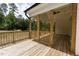 View of the home's wooden porch with wood railing and ceiling fan, ideal for enjoying the outdoors at 225 Whistlers Cv, Louisburg, NC 27549