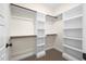 Organized walk-in closet with white shelving, wood trim, and ample storage space for a clutter-free lifestyle at 225 Whistlers Cv, Louisburg, NC 27549