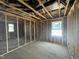 A room under construction features exposed beams, insulation, framing, and bright window views at 236 Norman Ave, Lillington, NC 27546