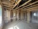 A spacious, unfinished room with wood frame, beams, and a window to the outside at 236 Norman Ave, Lillington, NC 27546