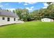 Expansive backyard featuring a well-manicured lawn and a detached garage, perfect for outdoor activities at 2430 Josephine Rd, Garner, NC 27529