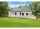 A broad backyard with a lush green lawn and a charming home offers a serene outdoor space at 2430 Josephine Rd, Garner, NC 27529