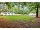 Expansive backyard features mature trees, a shed, and ample green space, enhancing privacy and potential at 2430 Josephine Rd, Garner, NC 27529