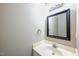 Updated half bath features new vanity, mirror and fixtures at 2430 Josephine Rd, Garner, NC 27529