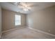 Neutral bedroom with a large window providing natural light, with a ceiling fan and standard outlet at 2430 Josephine Rd, Garner, NC 27529
