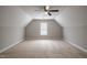 Spacious bonus room with ample natural light and a ceiling fan, perfect for various activities at 2430 Josephine Rd, Garner, NC 27529
