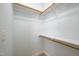 Spacious walk-in closet with wooden rods and shelving offers ample storage space at 2430 Josephine Rd, Garner, NC 27529
