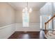 Dining room with hardwood floors, a large window, and views of the front yard at 2430 Josephine Rd, Garner, NC 27529