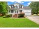 Charming two-story home with a well-manicured lawn and attached two car garage at 2430 Josephine Rd, Garner, NC 27529