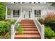 Inviting front porch with brick steps and lush landscaping leading to the front door at 2430 Josephine Rd, Garner, NC 27529