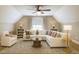Bright living room featuring vaulted ceilings, ceiling fan, comfortable furniture, and natural light at 2430 Josephine Rd, Garner, NC 27529