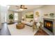 Comfortable living room with a fireplace, neutral decor, and lots of natural light at 2430 Josephine Rd, Garner, NC 27529
