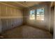 Bedroom featuring raw walls, bare floors, and two windows providing natural light at 246 Norman Ave, Lillington, NC 27546