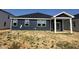 Home exterior with blue siding, a dark roof, and white trim, awaiting landscaping at 246 Norman Ave, Lillington, NC 27546