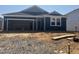 New home with blue siding and two-car garage awaiting landscaping and finishing touches at 246 Norman Ave, Lillington, NC 27546