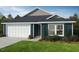 Charming single-story home with a two-car garage, blue siding, and a well-manicured lawn at 246 Norman Ave, Lillington, NC 27546